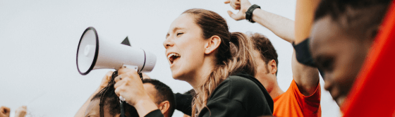 A young person using a megaphone.