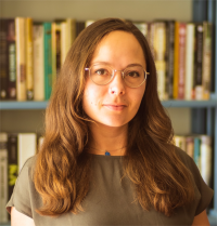 Kate is featured wearing a green blouse in the forefront, with a library as her backdrop.